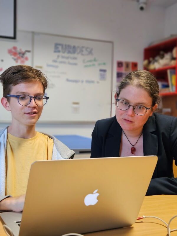 Two people working at computer
