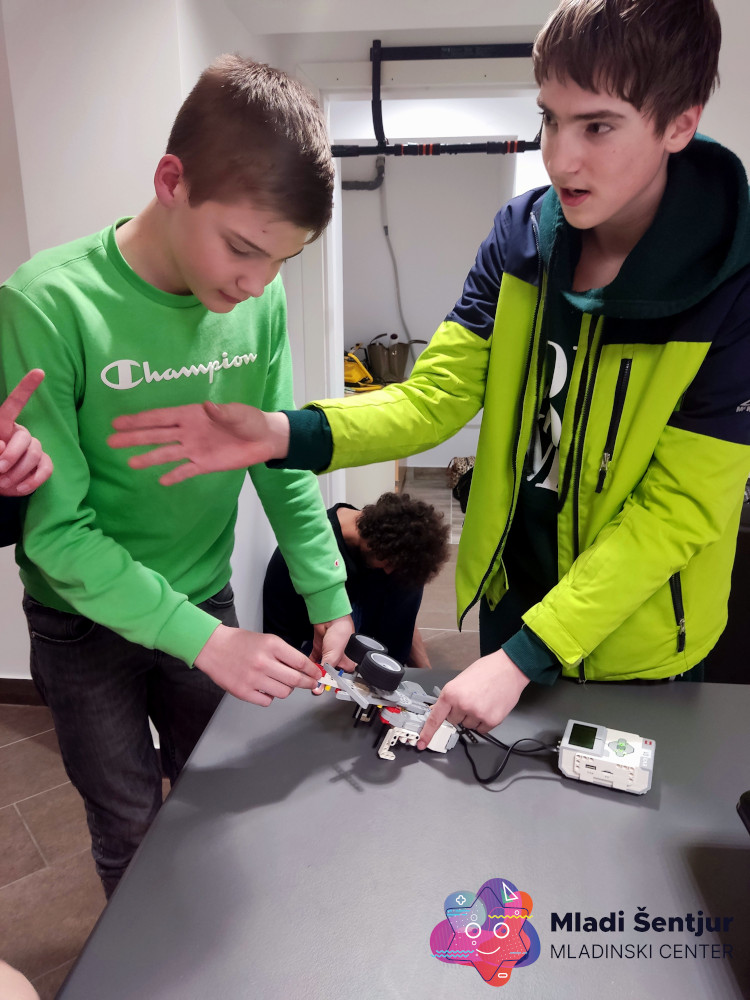 Mladi preizkušajo svoje Lego robote.